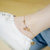 简约18k玫瑰金色脚链女 韩版气质五铜钱铃铛钛钢足链防过 敏(米白色)第4张高清大图